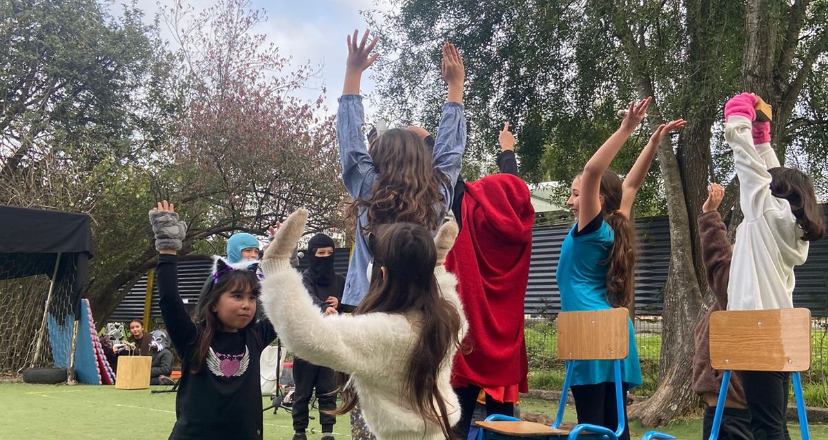 Niñas y niños jugando y actuando al aire libre